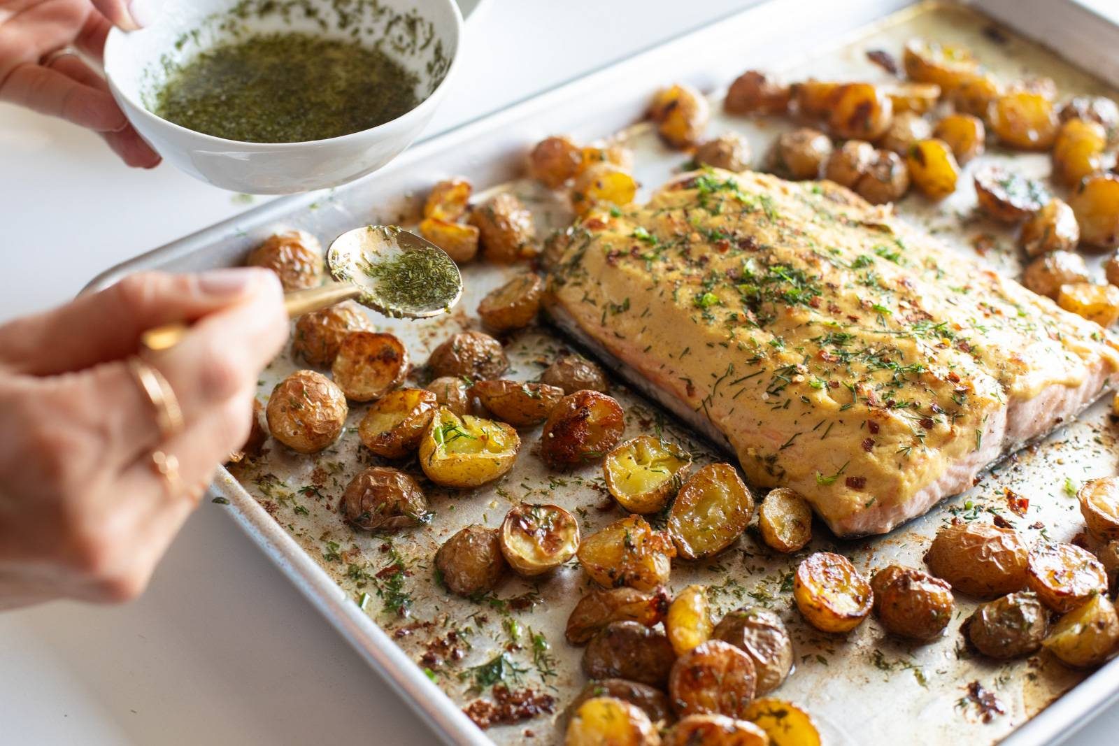 Salmon and potatoes on a sheet pan after cooking.