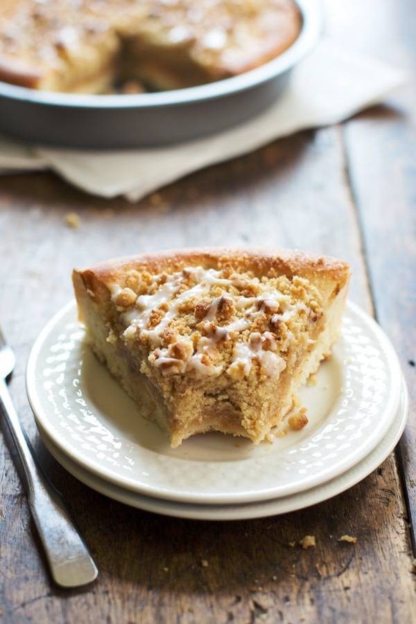 Deep Dish Cinnamon Streusel Dessert Pizza with a bite taken out on a white plate.