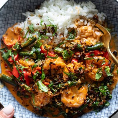 Shrimp curry in a bowl with rice.