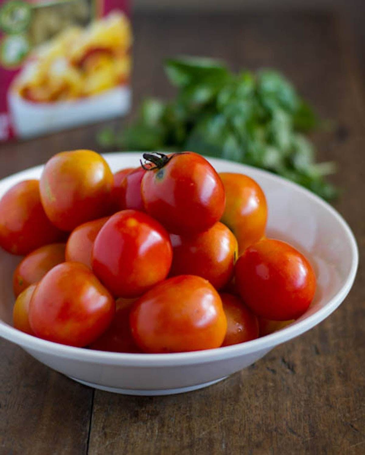 Tomatoes in a white dish.