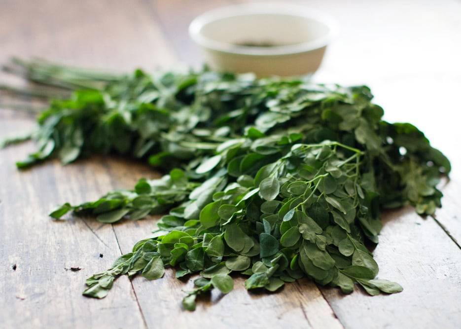 Herbs on a wooden surface.