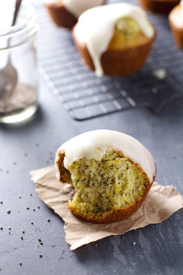 Lemon muffins with glaze on a piece of paper.
