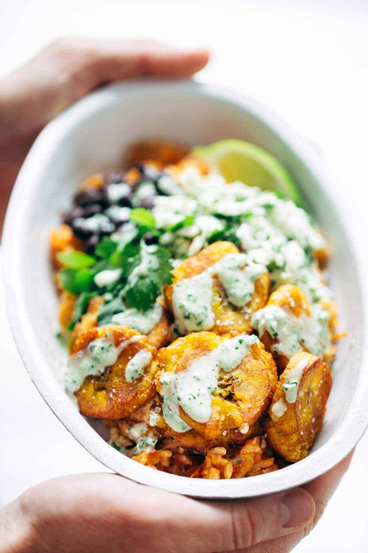 Spicy Brazilian Burrito Bowls recipe featuring seasoned rice and beans, garlic cilantro lime slaw, and crispy fried plantains. So good // almost vegan. | pinchofyum.com Spicy Brazilian Burrito Bowls recipe featuring seasoned rice and beans, garlic cilantro lime slaw, and crispy fried plantains. So good // almost vegan. | pinchofyum.com