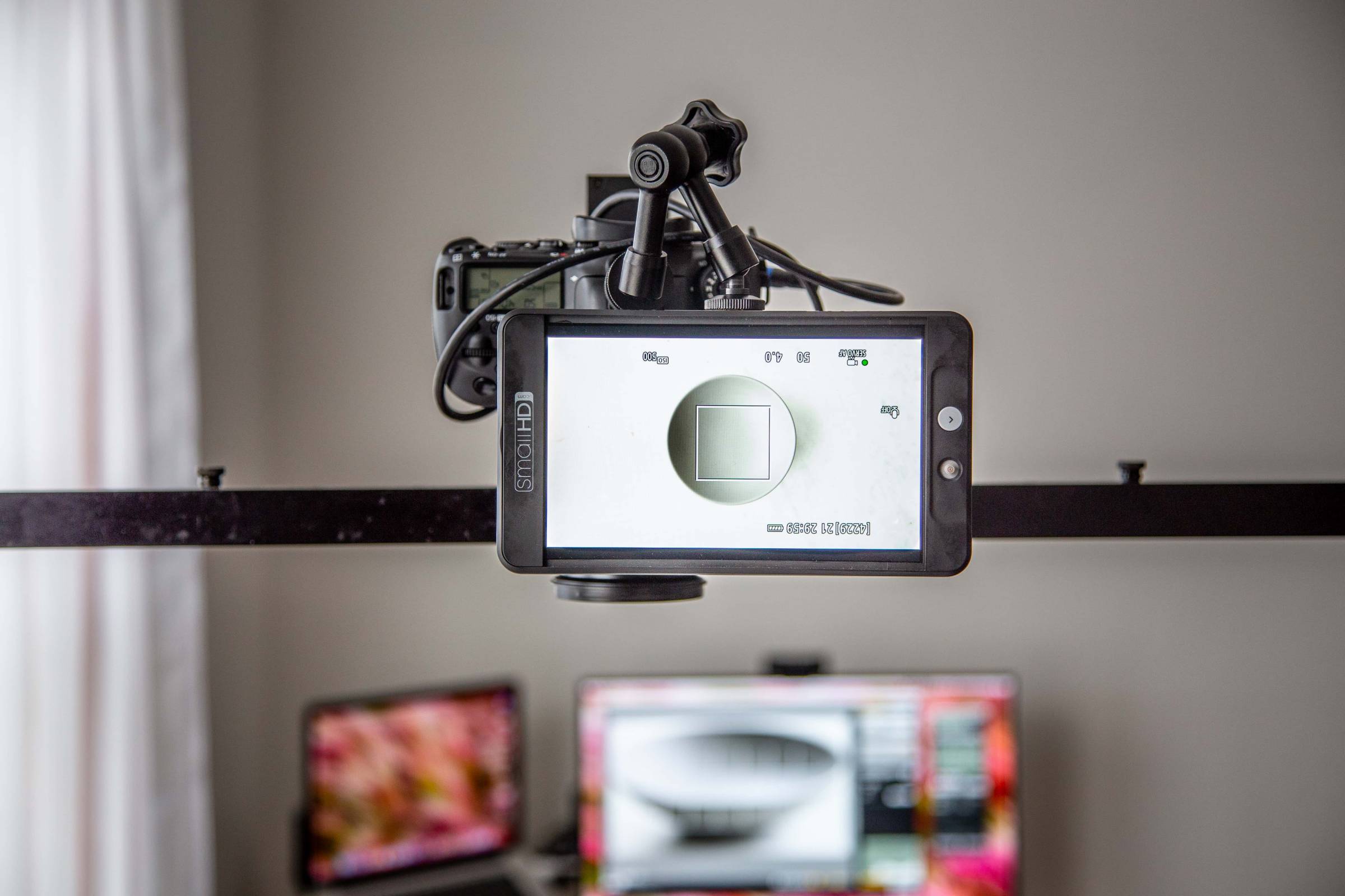 SmallHD monitor connected to DSLR camera on an overhead stand.