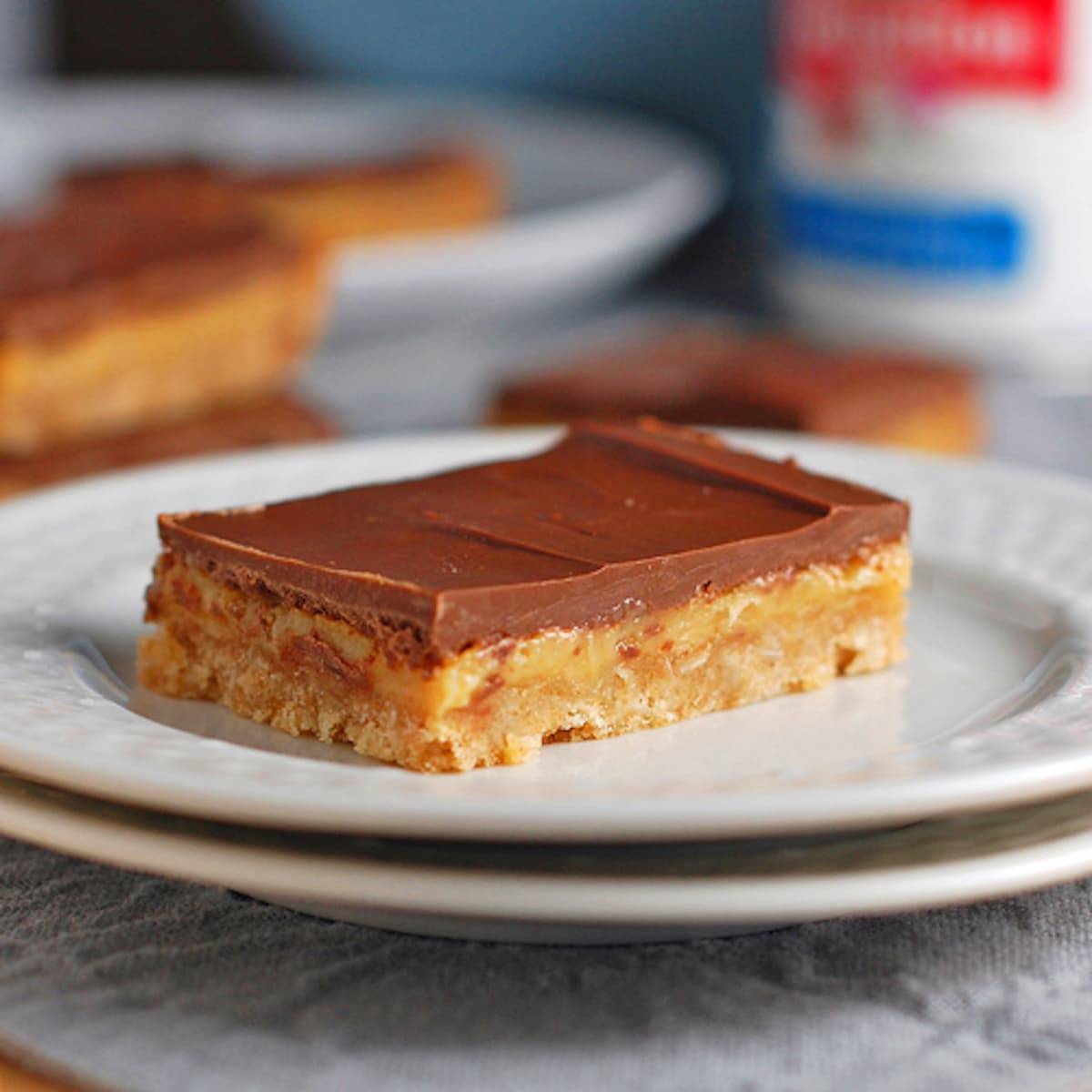 Milk chocolate dulce de leche bar on a white plate.