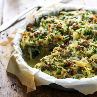 Sausage Potato Pie in a dish with parchment paper.