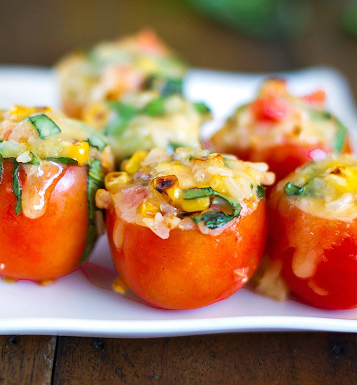 Stuffed tomatoes filled to the brim with roasted corn, fresh basil, and topped with melted Mozzarella cheese.